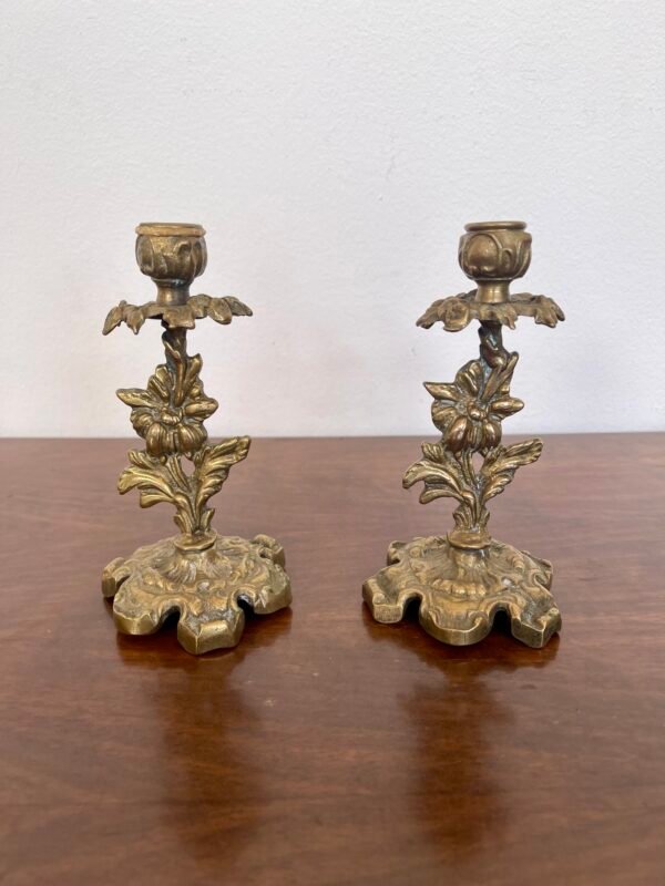 Coppia di eleganti portacandele vintage in bronzo lavorato, con raffinati dettagli floreali e base ornamentale